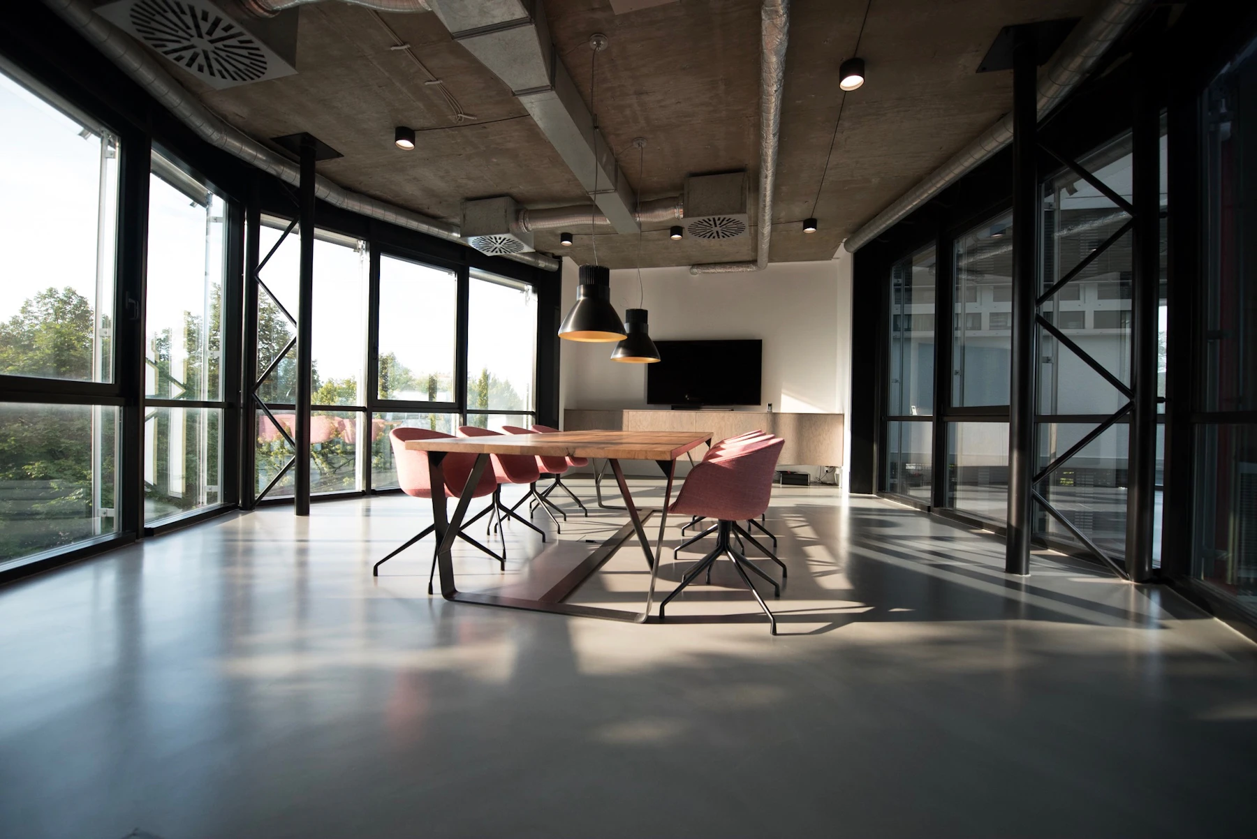 Modern renovated commercial office interior with glass meeting rooms